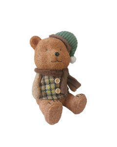 Orsetto natalizio seduto con cappello verde e sciarpa in tessuto